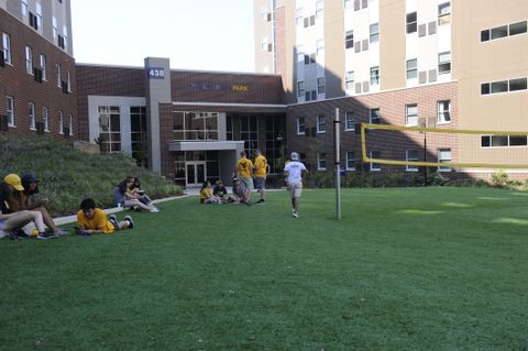 students with volleyball net in yard